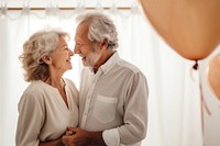 Senior couple celebrating birthday together balloon adult affectionate. 