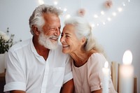 Senior couple celebrating birthday together laughing adult togetherness. 