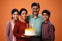 Indian family celebrating birthday dessert party food. 