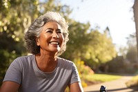 Senior hispanic woman riding a bicycle laughing adult smile. 