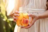 Woman holding fruit infused water, close-up photo. AI generated image by rawpixel.