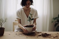 Woman planting a houseplant . AI generated Image by rawpixel.