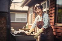 Asian women wearing apron standing cleaning house. 