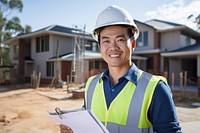Asian man wearing hard hat holding clipboard standing hardhat helmet. AI generated Image by rawpixel.