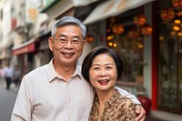 Old asian couple standing laughing portrait. 