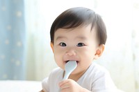 Baby eating spoon toothbrush innocence. 