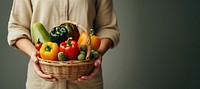 Woman holding vegetables basket fruit plant food. 