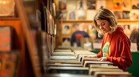 A photo of person selecting vinyl records in a retro record store.  