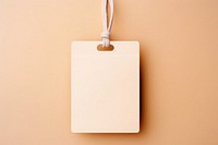 Blank craft paper label hanging accessories electronics. AI generated Image by rawpixel.