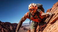 Photo of a african american hikier go rock climbing.  