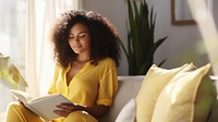 Photo of A relaxed trendy mixed-race african middle aged woman with long wavy hair with book.  