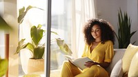 Photo of A relaxed trendy mixed-race african middle aged woman with long wavy hair with book.  