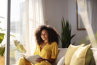 Photo of A relaxed trendy mixed-race african middle aged woman with long wavy hair with book. AI generated Image by rawpixel. 