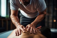 Therapist giving lower back sports massage patient spirituality relaxation. 