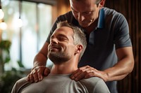 Therapist giving shoulder massage adult male togetherness. AI generated Image by rawpixel.
