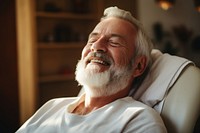 Old man getting a massage therapy laughing adult happy. 