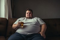 Overweight man sitting beer portrait glass. 