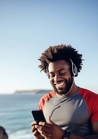 Photo of Portrait of a smiling afro-american sports man stretching his muscular arms before workout by the sea.  