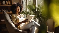 Photo of an african women wearing casual clothes reading book on an armchair, modern livingroom. AI generated Image by rawpixel. 