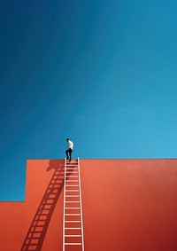 Photography of a man climbing a ladder to the roof.  