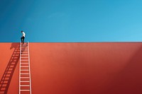 Photography of a man climbing a ladder to the roof.  