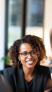 close up photo of a black middle age female lawyer with clients.  