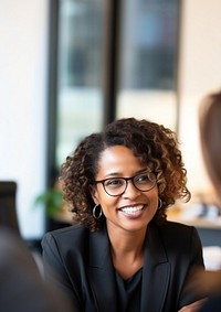 close up photo of a black middle age female lawyer with clients.  