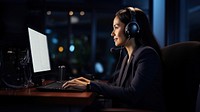 Photo of Businesswoman with headphones smiling during video conference. 