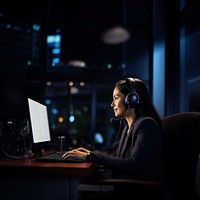 Photo of Businesswoman with headphones smiling during video conference. 