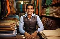 Indian Cloth merchant smiling sitting smile. 