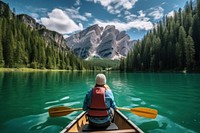 Young woman kayaking lake mountain outdoors. 