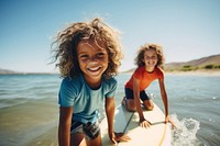 Two diversity cool kids surfing outdoors sports nature. 