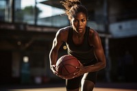 A dark-skinned female basketball athlete sports. 