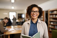 African-American female professional wearing glasses book publication smiling. 