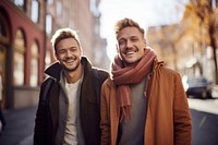 Gay couple laughing outdoors smiling. 