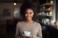 Woman holding a tea smiling coffee smile. 