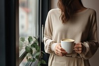 Window coffee sweater holding. 