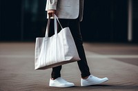 White tote bag footwear carrying handbag. 