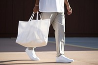 White tote bag footwear carrying handbag. 