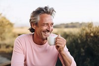 Man drinking tea smiling smile mug. 