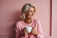 Woman drinking tea smiling smile pink. 