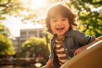 Kid japanese laughing portrait outdoors. 