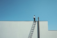 Man climbing outdoors ladder roof. 