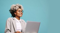 Female looking upward while reading communicating online using silver laptop.  