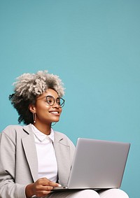 Female looking upward while reading communicating online using silver laptop.  