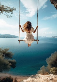 Traveler woman relaxing on swing above sea.  