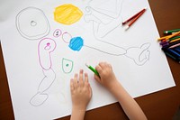 Child drawing on paper table representation handwriting.