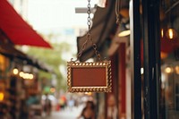 Sign hanging street store. 