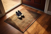 Welcome mat on a house wood floor with shoes and boxes flooring hardwood footwear.