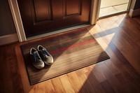 Welcome mat on a house wood floor with shoes and boxes flooring hardwood footwear.